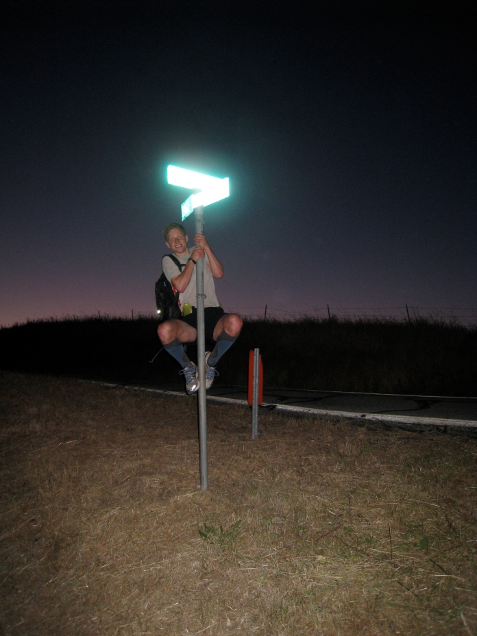 Ben climbing the signpost at "his favorite intersection in the world," Alpine and Page Mill. Roughly 12 miles and 1500' in and dawn just creeping over the horizon.